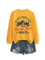 Detail of ginger yellow sweatshirt with camp fire nights graphic and frayed denim shorts - Yellow