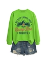 Flat lay of lime green crewneck sweatshirt with camping print and ripped denim shorts - Fluorescent Green