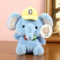 Detail of blue plush elephant toy wearing a yellow baseball cap and colorful bells - Approx. 16cm / Elephant