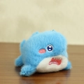 Cute blue shark plush keychain with soft long fur and detailed embroidery on wood surface - Blue Shark