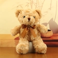 Light brown plush teddy bear with a dark brown satin bow on a warm wooden background - Light Brown with Brown Ribbon