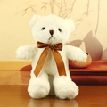 Classic white plush teddy bear with a brown satin bow on a dark wood table - White with Brown Ribbon