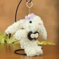White plush bunny keychain featuring purple knit flower and elegant pearl bow detail - Around 18cm / Purple Accessories
