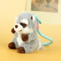 Gray and white plush raccoon keychain with brown limbs and light blue lanyard - Gray