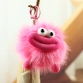 Porte-clés monstre en peluche rose avec grosses lèvres et fermoir métallique sur une branche - Grande Bouche Rouge