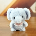 Light blue plush elephant keychain with pink checkered bib on wooden surface - F Elephant