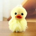 Cute yellow plush duck keychain with fluffy long fur and orange beak on wooden surface - Grass Skirt Style (F Yellow Grass Skirt) / Yellow / About 13-15cm