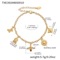 Detail van de gouden roestvrijstalen armband met vlinder- en zonnebloembedels - Armband / Goud