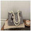 Detail of leopard print tote bag with braided rope handles and decorative charm - With Pendant / Off White