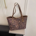 Large leopard print tote bag with brown leather handles and golden rivet details - Brown