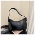 Detail of glossy black patent leather underarm bag with silver zipper and embossed logo - Black