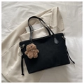 Detail of black trapezoid tote bag with brown plush bear charm and long leather handles - With Charm / Black