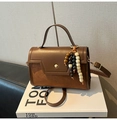 Detalle de bolso bandolera vintage marrón con borla étnica y cierre de metal redondo - Marrón Con Colgante De Perlas De Madera