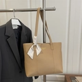 Khaki large capacity tote bag with silk scarf on a hanger next to a gray suit - Khaki