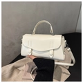 Detail of minimalist beige top-handle crossbody bag with refined envelope flap and stitching - White