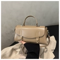 Detail view of khaki faux leather handbag with twin round buckle accents and stitching - Khaki