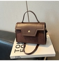 Detail of brown leather bag with gold buckle on Tom Ford fashion book - No Pendant / Brown