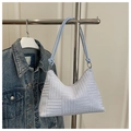 Close-up of geometric embossed texture and rope strap detail on light purple tote bag - Blue