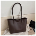 Close-up of a vintage dark brown tote bag with premium lychee grain texture and embossed logo - Black