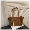 Detail of brown faux suede tote bag featuring a colorful beaded charm and buckle strap - Brown with Pendant