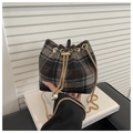 Detailed view of plaid wool bucket bag featuring gold chain and pearl drawstring charms - Black