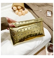 Detail of a gold metallic clutch with silver rivets and sleek envelope flap closure - Gold