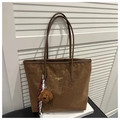 Detail of leopard print tote bag with plush bear charm and elegant gold branding - With Charm / Brown
