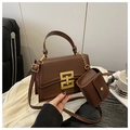 Detail of dark brown box bag with gold lock, accordion structure and matching mini pouch - Main Bag Only / Brown