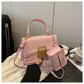 Detailed shot of pink crossbody bag featuring gold hardware and matching mini pouch - Main Bag Only / Pink