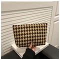 Detail of diamond weave pouch showing coffee and beige knitted texture and trapezoid shape - Brown