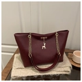 Burgundy textured leather tote bag with gold chain strap and deer pendant detail - Red