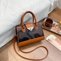 Vintage brown crocodile textured handbag with sleek golden clasp and crossbody strap - Brown