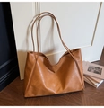 Close-up of vintage brown tote bag featuring soft pleated faux leather and long straps - Brown