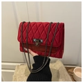 Quilted velvet shoulder bag in deep red featuring chain strap and metallic lock closure - Red