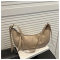 Detailed close-up of a beige crescent hobo bag featuring a sleek golden logo plate - Khaki