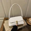 Chic white baguette underarm bag featuring a vintage oval gold buckle lock on beige fabric - White