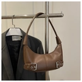Detail view of brown hobo crescent bag with silver buckles and smooth matte leather finish - Brown