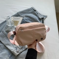 Light pink nylon crossbody bag with dual zipper compartments and adjustable fabric strap - Pink
