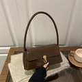 Dark brown patent leather baguette bag with minimalist gold metal buckle and long shoulder strap - Brown