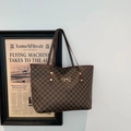 Brown monogram tote bag with M pattern and gold bow charm on white background - Coffee