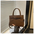 Detail of brown leather handbag with buckle strap and silver studs for casual daily use - Brown