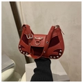 Red rivet handbag featuring mixed leather and suede textures with silver metal studs - Red