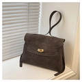Detailed view of dark brown vintage briefcase with golden hardware on white windowsill - Brown