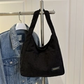 Chic black corduroy tote bag with wide strap and fashion tag in retro casual style - Black