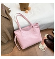 Detail shot of pink embossed tote bag with cat patterns and side drawstring texture - Pink