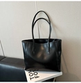 Macro shot of black tote bag featuring crinkled glossy leather texture and thin straps - Black without Pendant