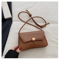 Detail of minimalist brown baguette bag featuring a gold square buckle and cord strap - Brown