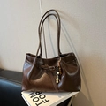 Dark brown faux leather shoulder tote bag featuring a decorative beaded charm and buckle - With Charm / Glossy Coffee
