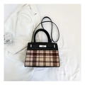 Detail of black and pink plaid handbag with silver metal twist lock on white blazer - Black 6011