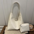 Minimalist cream hobo shoulder bag set with matching zipper pouch on cozy texture - Off White